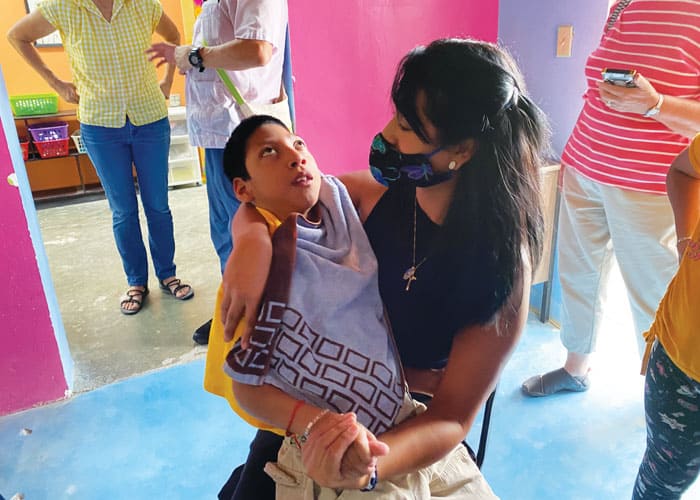 Helena Niño de Guzmán, a participant in the Maryknoll border immersion trip, holds Jesús Manuel Martínez at the Santo Niño Center in Ciudad Juarez. (Tracy McNulty/Mexico)