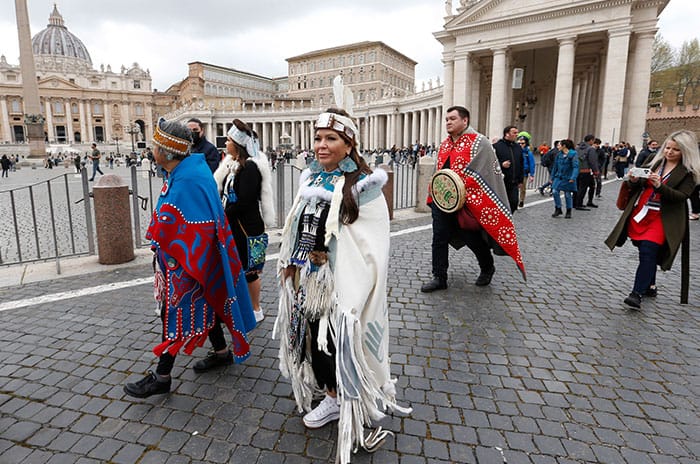 Canadian Indigenous delegates walk outside St. Peter's Square after a meeting with Pope Francis at the Vatican April 1, 2022. The pope apologized for the treatment of Indigenous in Canada and promised to visit. (CNS photo/Paul Haring)