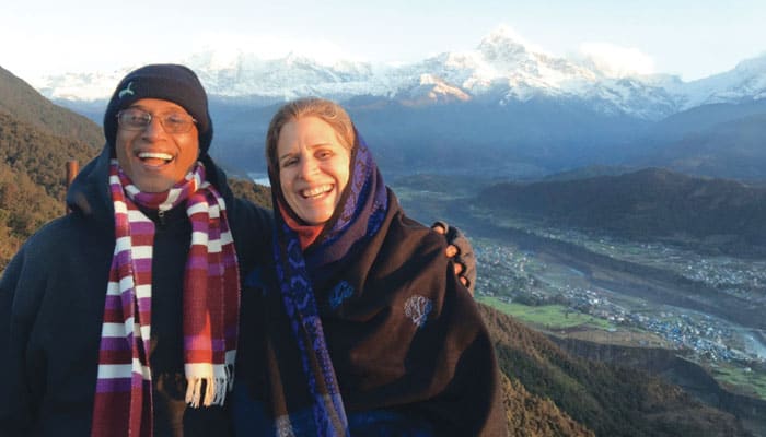 Merwyn and Kirstin De Mello, who worked in Afghanistan, are shown while on retreat in Nepal with the Himalayan Mountains in the background. (Courtesy Merwyn De Mello/Nepal)