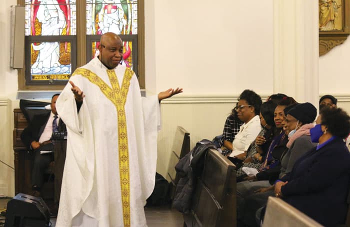 Father St. Vil’s engaging homily draws appreciative laughter from listeners attending a monthly Creole-language day of worship. (Diane Mastrogiulio/U.S.)