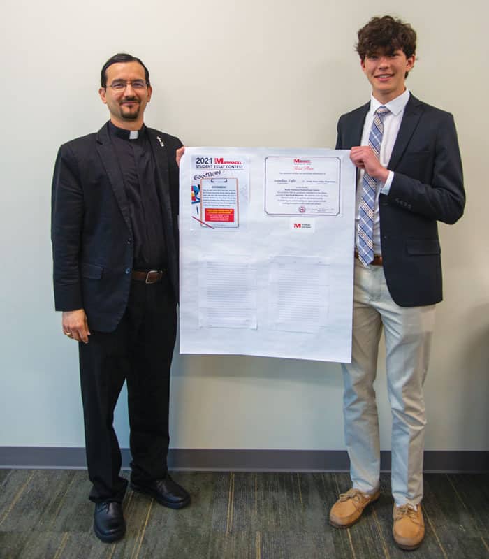Maryknoll Father Rodrigo Ulloa-Chavarry presents the first-place Bishop Patrick J. Byrne Award for Division II of the Maryknoll Student Essay Contest to Jonathan Taffet, a 12th grader at Strake Jesuit College Preparatory School in Houston, Texas. (Courtesy Rodrigo Ulloa-Chavarry)