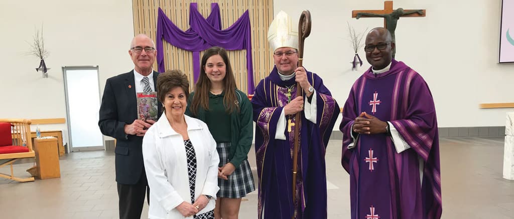 Isabel Lombardi, a 7th grader at St. Michael the Archangel School in Canton, Ohio, receives the first-place Bishop Francis X. Ford Award for Division I of the Maryknoll Student Essay Contest with her principal, Claire Gatti, Deacon Paul Bork, Bishop David Bonnar of Youngstown and Father Benson Okpara, pastor. (Norman Kunz/U.S.)