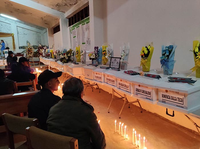 Relatives of victims of the 1985 massacre in Accomarca, Peru, keep vigil with the remains of their loved ones in the village church 18, 2022. Hundreds of people gathered in the tiny Andean village for the burial of the remains of 50 victims of a brutal massacre committed by Peruvian soldiers in 1985. (CNS photo/Jacqueline Fowks)