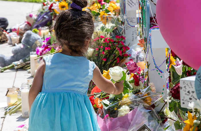Scenes from a memorial site in downtown Uvalde, Texas, show grieving family and community members leaving messages, flowers and other offerings to honor the 21 people, 19 students and two teachers, killed in a mass shooting at Robb Elementary School on May 24, 2022. (Octavio Duran/U.S.)