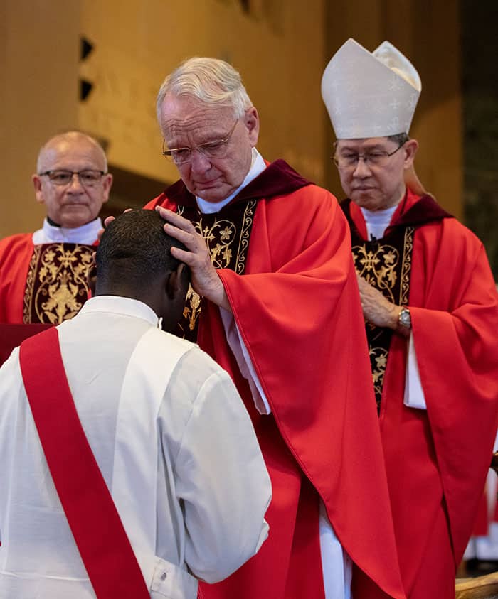 After World Mission Sunday Mass at St. Ferdinand Church, pastor Father Jason Torba and Cardinal Blase Cupich greet the congregation, including all those who do mission in Chicago. (Julie Jaidinger, Chicago Catholic/U.S.)