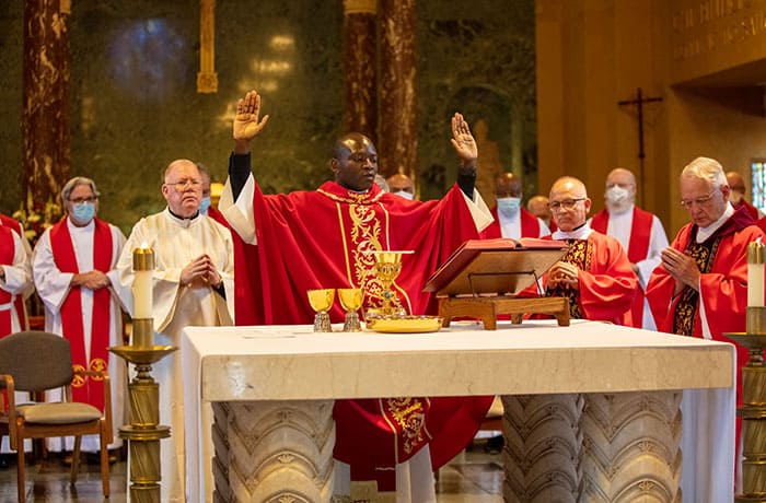 After World Mission Sunday Mass at St. Ferdinand Church, pastor Father Jason Torba and Cardinal Blase Cupich greet the congregation, including all those who do mission in Chicago. (Julie Jaidinger, Chicago Catholic/U.S.)