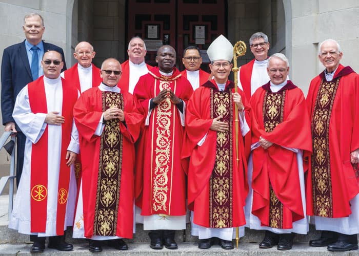 Father Siyumbu poses with presider Cardinal Luis Antonio Tagle, Mass concelebrants and missioners. (Octavio Duran/U.S.)