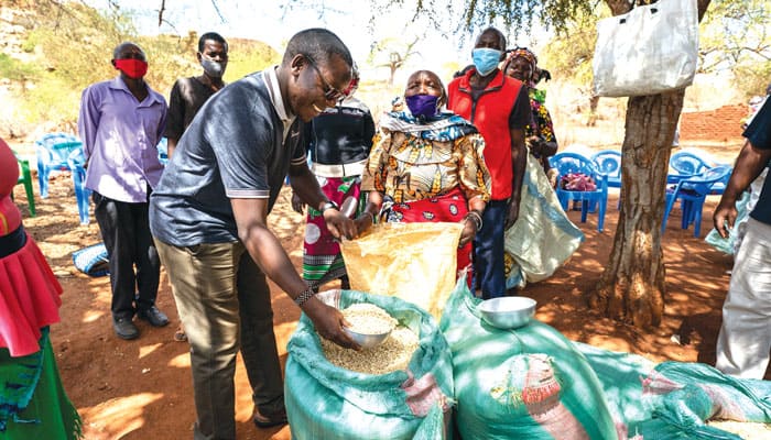 Dominic Mutunga, who connected Father Lance Nadeau to the needs of people in the Kibwezi area, helps distribute food at the Dunguni outstation of the St. John the Baptist mission. (Gregg Brekke/Kenya)