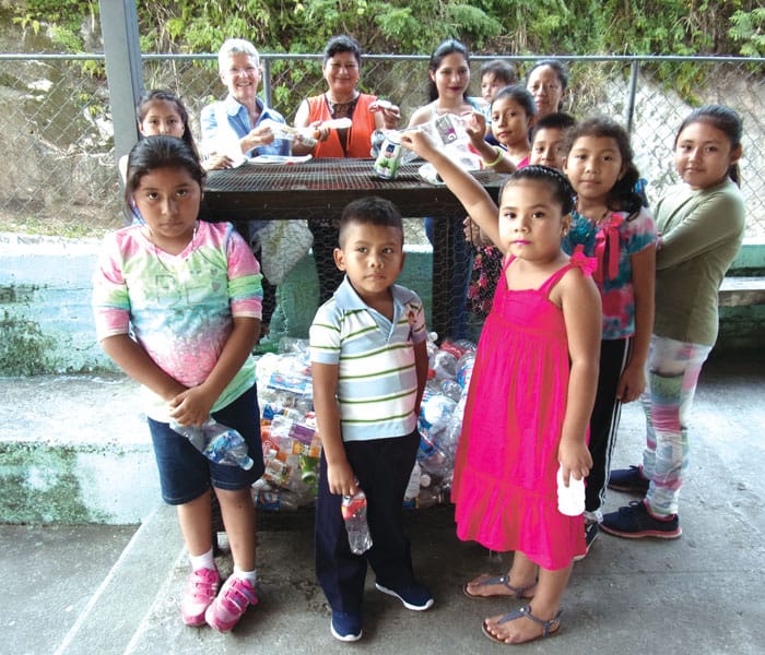 Maryknoll Lay Missioner Margaret Vámosy and adult community leaders teach children of the village of San Nicolás to recycle. (Courtesy Margaret Vámosy/El Salvador)