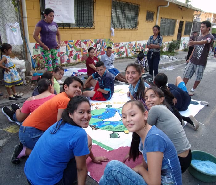 7-a parish youth group creates an environment-themed street mural made of colored salt for Good Friday