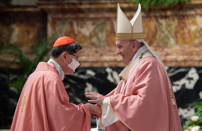 After World Mission Sunday Mass at St. Ferdinand Church, pastor Father Jason Torba and Cardinal Blase Cupich greet the congregation, including all those who do mission in Chicago. (Julie Jaidinger, Chicago Catholic/U.S.)