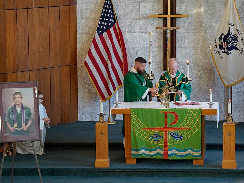 New York Auxiliary Bishop Peter J. Byrne is assisted by Deacon Charles Carroll as he celebrates a Mass marking the 55th anniversary of the death of Maryknoll Father Vincent R. Capodanno at Fort Wadsworth in Staten Island, N.Y., Sept. 4, 2022. (CNS photo/Gregory A. Shemitz)