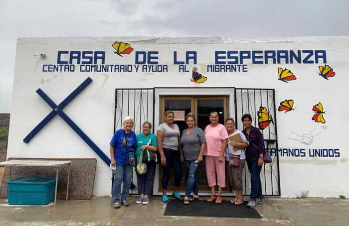 (Left to right) Gail Kocourek, Maryknoll Sister Joy Esmenda, three volunteers, Dora Luz Rodriguez and Maryknoll Sister Genie Natividad gather at Casa de la Esperanza welcome center on the Mexican side of the border in Sasabe, Sonora. (Courtesy of Genie Natividad/U.S.)