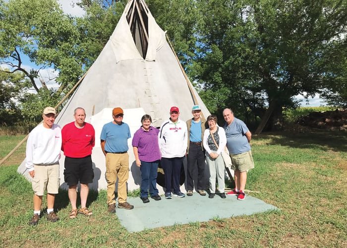 Participants in the Maryknoll immersion trip visit the teepee of their Lakota guide, an associate professor at the University of South Dakota. (Courtesy of Scott Giblin/U.S.)