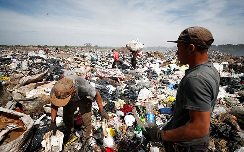 CELAM report on synodality-Waste recyclers look through heaps of waste for cardboard, plastic and metal, at a landfill in Buenos Aires, Argentina, Oct. 5, 2022. The recyclers work 12-hours shifts as Argentina faces one of the world's highest inflation rates, set to top 100% this year. Among the challenges identified during the process of the Latin American church's First Ecclesial Assembly were social and economic inequalities exacerbated by the pandemic. (CNS photo/Agustin Marcarian, Reuters)