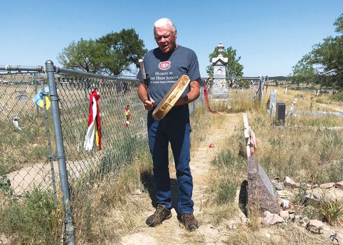 Lakota Chief Gary Cheeseman sings and drums at the ceremonial site, an Indigenous graveyard, where the Maryknoll immersion trip began and concluded. (Scott Giblin/U.S.)