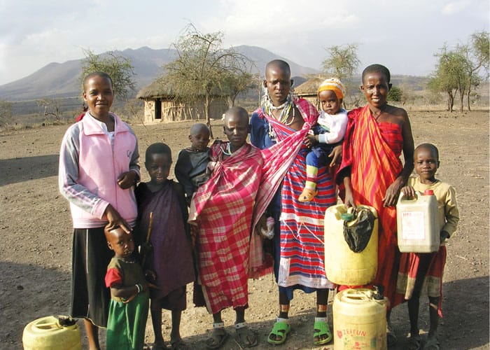 24-29-Emusoi-Tanzania-04 Emusoi student Neema (far left) visits her family in her home village during a program break. After graduating from the center, Neema went on to earn a diploma in environmental health. To date, some 2,000 girls have graduated from Emusoi. (Courtesy of Mary Vertucci/Tanzania)