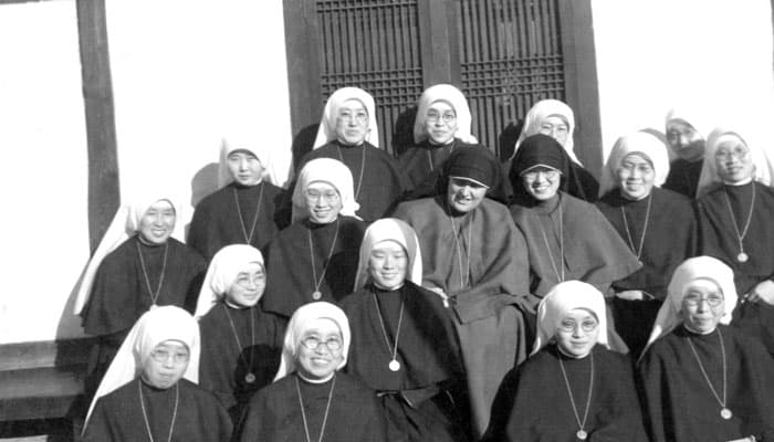 Maryknoll Sisters Sylvester Collins and Agneta Chang (right) are shown in 1939 with Our Lady of Perpetual Help novices. (Maryknoll Mission Archives)