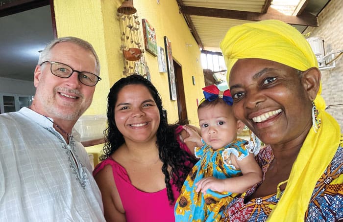 (From left) Maryknoll Father Dennis Moorman, a frequent collaborator, poses with Bruna Ferreira, her daughter Maria Cecilia and Maryknoll Sister Efu Nyaki. (Dennis Moorman/Brazil)