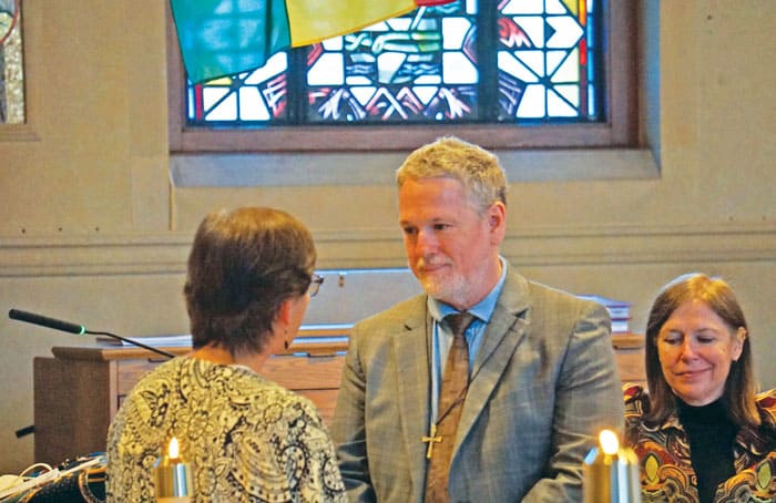 Class of 2022 candidate Michael Lattanzi receives his mission cross as his spouse, Susan Silveus, looks on. (Debbie Northern/U.S.)