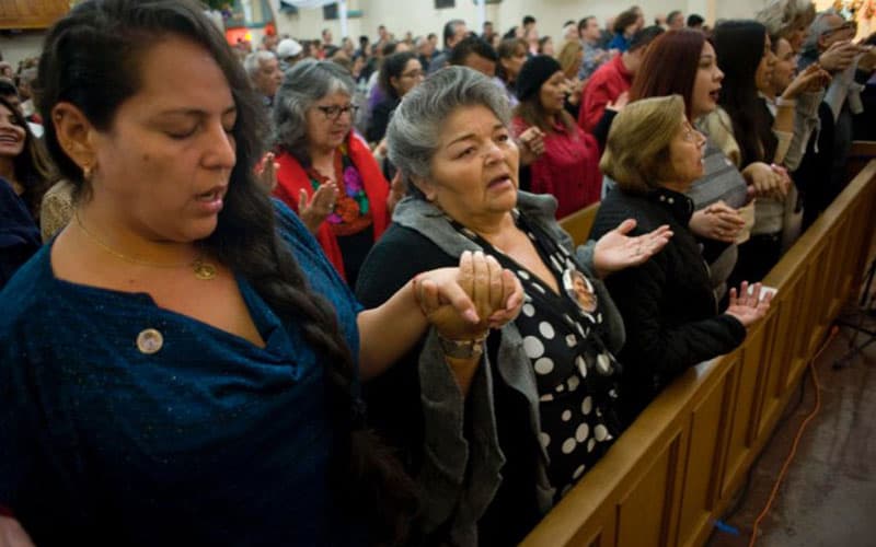 20230417T1925-PEW-US-LATINOS-FAITH-1758453 After World Mission Sunday Mass at St. Ferdinand Church, pastor Father Jason Torba and Cardinal Blase Cupich greet the congregation, including all those who do mission in Chicago. (Julie Jaidinger, Chicago Catholic/U.S.)