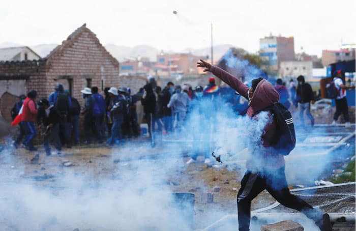 Demonstrators clash with security forces near the Juliaca airport during a Jan. 9, 2023, protest demanding early elections and the release of the former president. (OSV News/Hugo Courotto, Reuters)