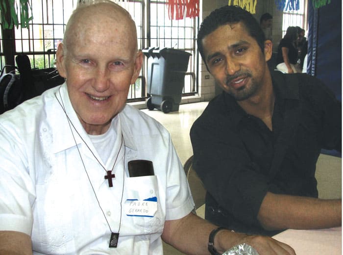 52-55-Serving-the-Poor-02 The late Maryknoll Father Gerard Kelly (left) is shown at a 2010 Encuentro Misionero Juvenil gathering with Mesias Pedroza, now 40, who leads multiple ministries in the Houston area.