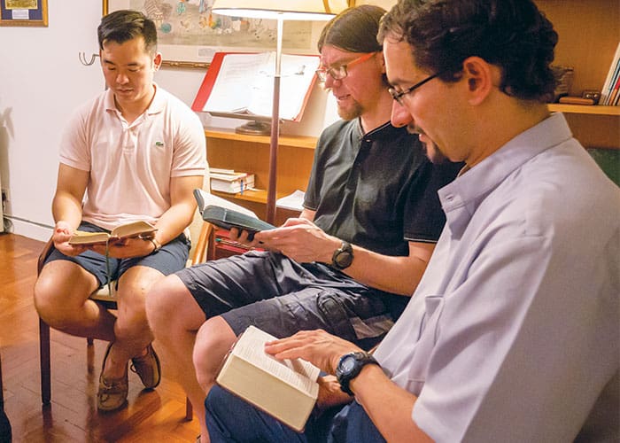 18-23-Fr-Ulloa-02 (Left to right) Maryknoll Fathers Daniel Kim, Shaun Crumb and Rodrigo Ulloa-Chavarry pray the Liturgy of the Hours at the Society house in Hong Kong. (Nile Sprague/Hong Kong)