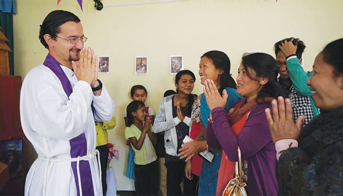 In Bandipur, Nepal, Father Ulloa-Chavarry shares a joyful moment of encounter with parishioners. (Sean Sprague/Nepal)