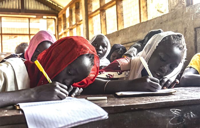 Girls in a refugee camp study in a JRS educational program. (Courtesy of Jesuit Refugee Service/South Sudan)