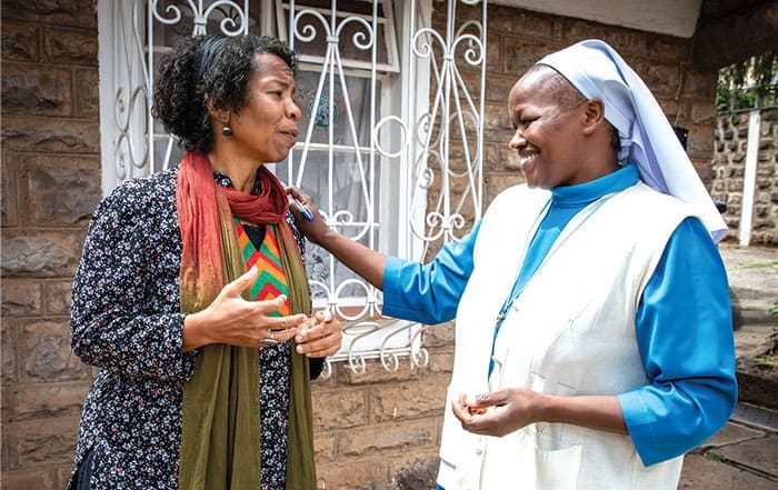 Dee Dungy, who joined the Maryknoll Lay Missioners in 2011, talks with Emmanuel Sister Beth Waithera (right), who works in a JRS livelihood program. (Jerry Fleury/Kenya)