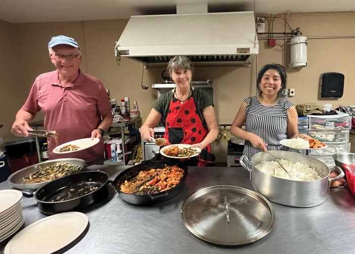 Deacon Bill Toller, Jeannine Clark and Guadalupe Jimenez (left to right) prepare a meal while visiting a migrant shelter during an immersion trip to El Paso, Texas. (Andrea Moreno-Diaz/U.S.)