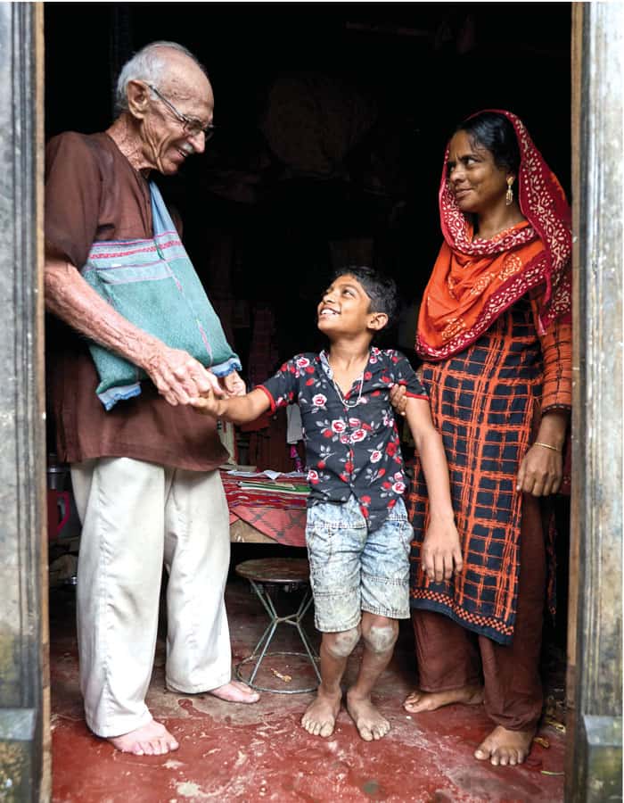 Maryknoll Father Robert McCahill visits the family of Monna, a 12-year-old in need of support for health care services, in the village of Nopara near Srinagar. (Paul Jeffrey/Bangladesh)
