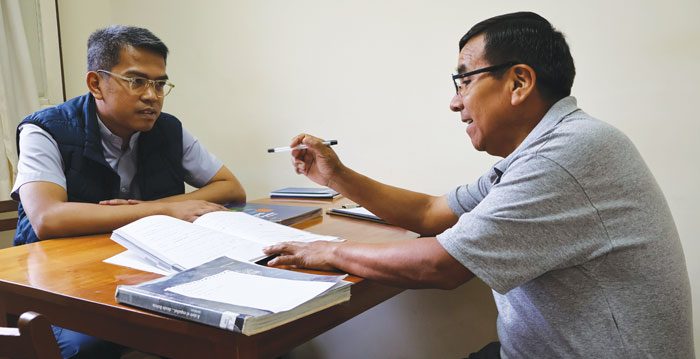Oscar Rosas (right) teaches Spanish to Father Melchor D. Andaya of the Philippines as the priest prepares for mission work in Latin America. (Adam Mitchell/Bolivia)
