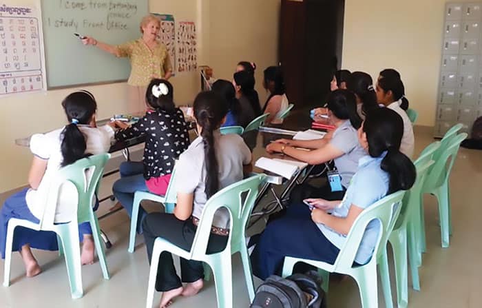 Maryknoll Sister Helene O’Sullivan instructs students at Horizons, a skills training program for low-income girls at risk for trafficking. (Courtesy of Maryknoll Sisters/Cambodia)