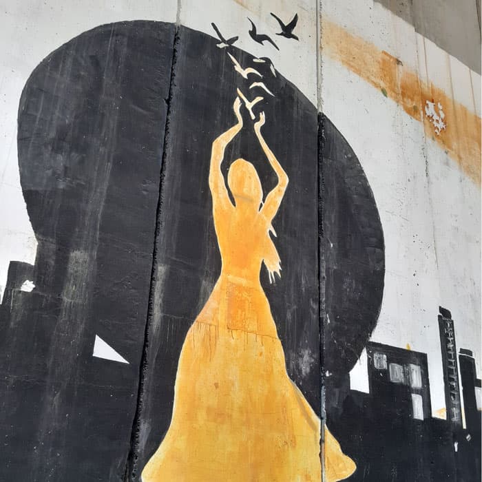 Artists have painted messages of resilience and hope on the concrete wall separating Bethlehem and Jerusalem, built to segregate Palestinians. (Susan Nchubiri/Palestine)