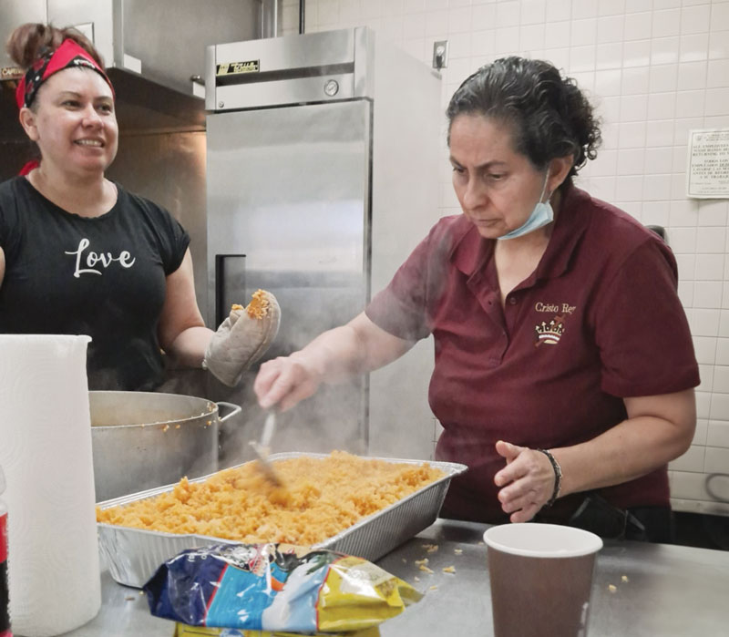 Cristo Rey parishioners Claudia Díaz and Gloria Ibarra (left, right) prepare hot meals for migrants and refugees staying at shelters in El Paso, Texas. (Courtesy of Gloria Ibarra/U.S.)