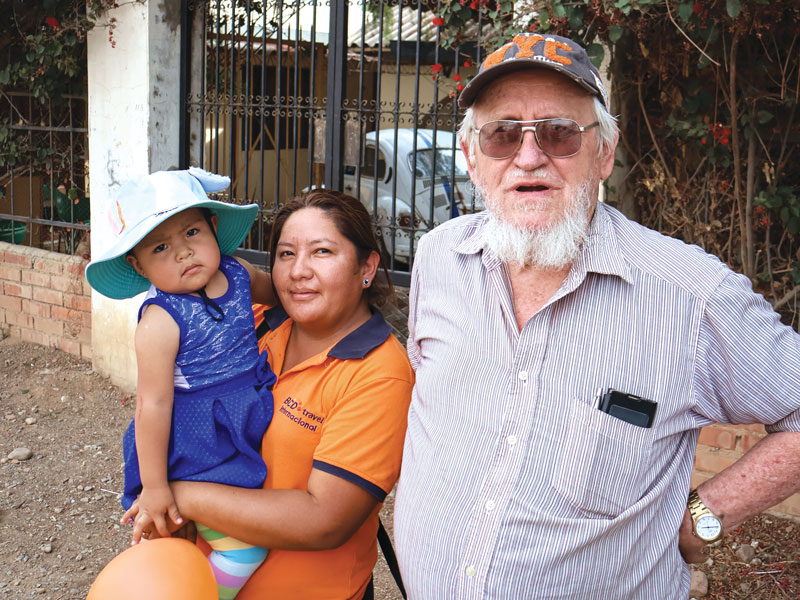 W25-sykora-escolar-3 Coordinator Jhovana Reyes, daughter Khyara, and Padre Pablo prepare for the day’s rounds at Nueva Vera Cruz chapel, where the Apoyo Escolar program started. (Adam Mitchell/Bolivia)
