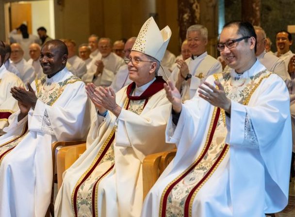 After World Mission Sunday Mass at St. Ferdinand Church, pastor Father Jason Torba and Cardinal Blase Cupich greet the congregation, including all those who do mission in Chicago. (Julie Jaidinger, Chicago Catholic/U.S.)