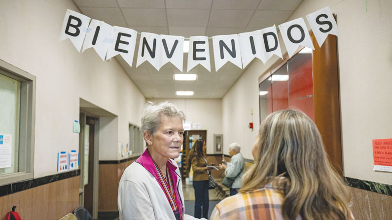 Celine Woznica welcomes guests to St. Edmund Center. Since it began the project has received 19,000 migrant visits. (Octavio Durán/U.S.)