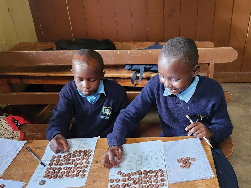 In the classroom, students benefit from Glaser’s creative teaching techniques such as activities to develop basic math skills and games to reinforce English language learning. (Courtesy of Theresa Glaser and Maryknoll Lay Missioners/Kenya)