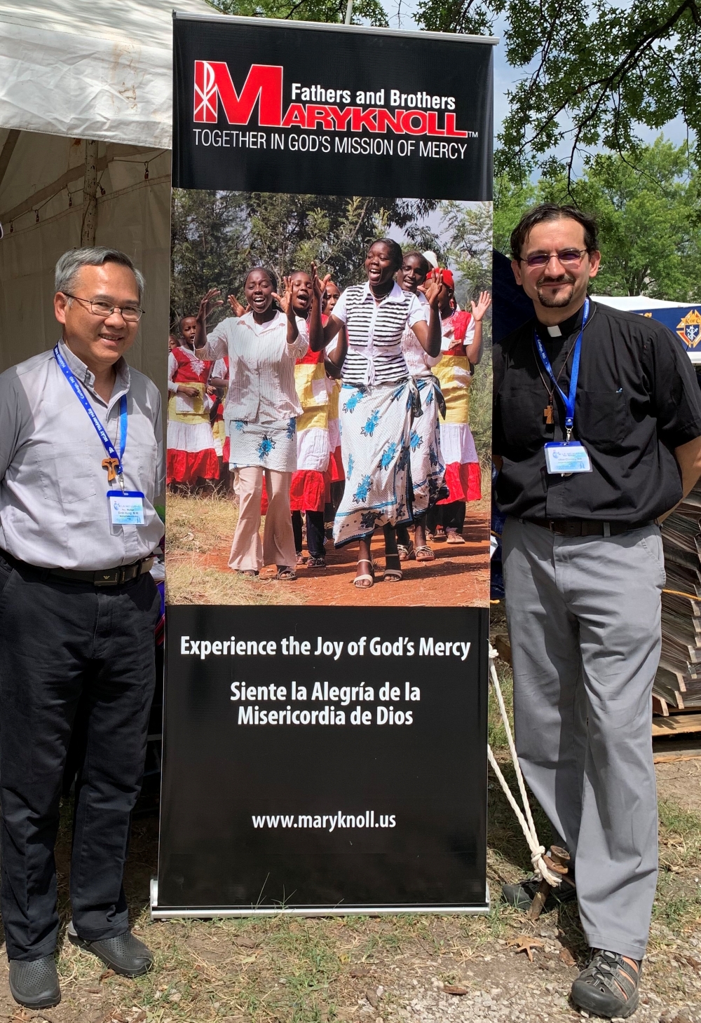 Maryknoll Father Rodrigo Ulloa and Maryknoll Father Hung M. Dinh pose with a banner sharing the missioner society's message about God's mercy, in an undated photo. As director of vocations for the Maryknoll Fathers and Brothers, Father Ulloa accompanies young people who are discerning a lifelong commitment to the mission as priests or brothers. (OSV News/courtesy of Father Rodrigo Ulloa, M.M.)