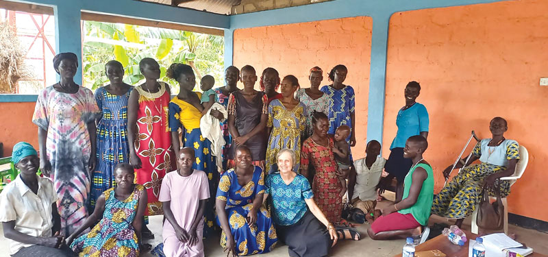 Maryknoll Lay Missioners Joanne Blaney (seated, in patterned blouse) and Marj Humphrey facilitated sessions in trauma therapy for 150 South Sudanese women refugees living at Palabek Refugee Settlement. (Courtesy of Maryknoll Lay Missioners/Uganda)