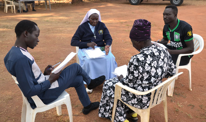 Program participants Sister Agness Driciru, Odong Philip, Adong Sabina and Nokrach Peter engage in a trust group, a learning technique that fosters dialogue and listening skills. The participants are being trained to lead conflict resolution in Gulu communities. (Courtesy of Maryknoll Lay Missioners/Uganda)