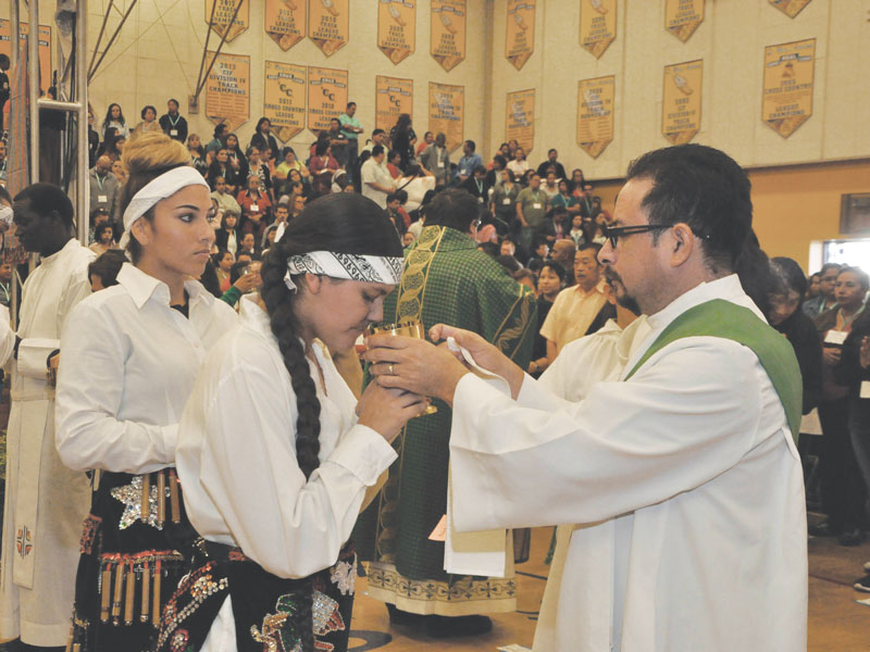 After World Mission Sunday Mass at St. Ferdinand Church, pastor Father Jason Torba and Cardinal Blase Cupich greet the congregation, including all those who do mission in Chicago. (Julie Jaidinger, Chicago Catholic/U.S.)