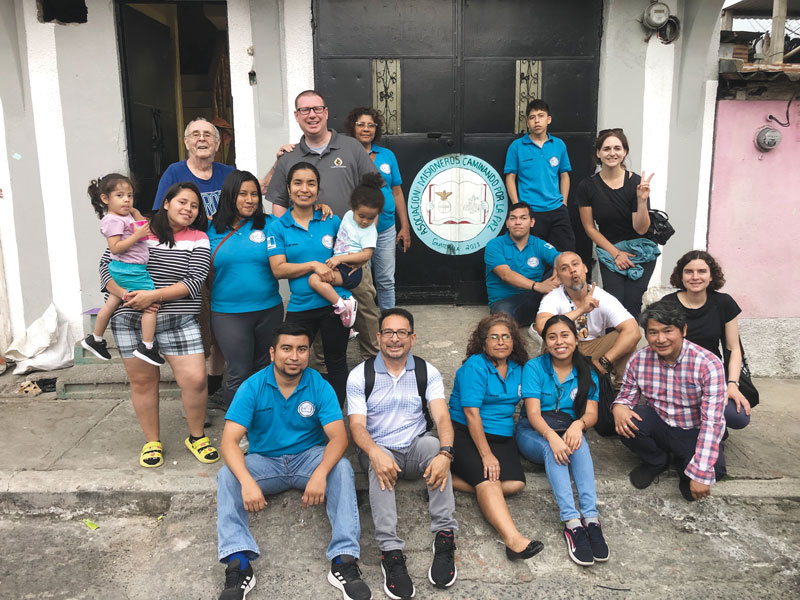 After World Mission Sunday Mass at St. Ferdinand Church, pastor Father Jason Torba and Cardinal Blase Cupich greet the congregation, including all those who do mission in Chicago. (Julie Jaidinger, Chicago Catholic/U.S.)