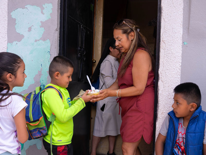 After World Mission Sunday Mass at St. Ferdinand Church, pastor Father Jason Torba and Cardinal Blase Cupich greet the congregation, including all those who do mission in Chicago. (Julie Jaidinger, Chicago Catholic/U.S.)