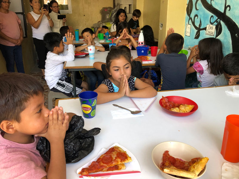After World Mission Sunday Mass at St. Ferdinand Church, pastor Father Jason Torba and Cardinal Blase Cupich greet the congregation, including all those who do mission in Chicago. (Julie Jaidinger, Chicago Catholic/U.S.)