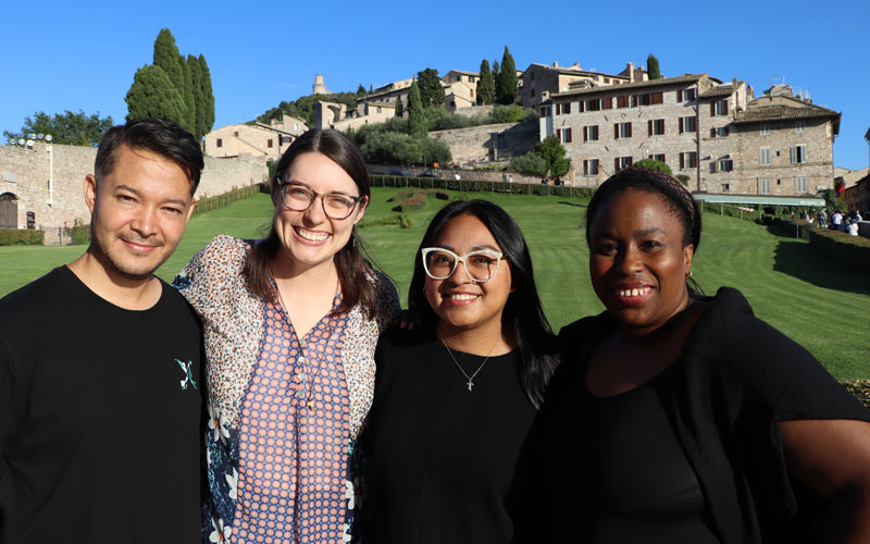 Maryknoll Young Adult Ambassadors (left to right) Andrés García, Brinkley Johnson, Luna Stephanie and Ogechi Akalegbere pause for a photo in Assisi, where they walked in the footsteps of St. Francis and meditated on his “Canticle of the creatures.” (Andrea Moreno-Díaz/Italy)