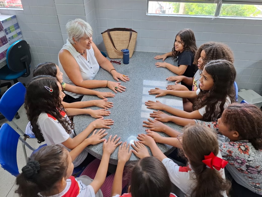 At Joacil Brito School, Maryknoll Lay Missioner Kathleen Bond leads girls in weekly group sessions run by the lay missioners and AFYA staff in 10 public schools. The sessions teach students how to manage anxiety and prevent violence. (Courtesy of Kathleen Bond/Brazil)